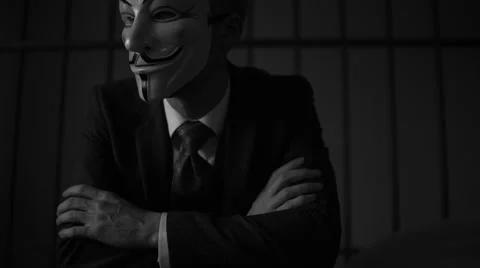 Anonymous hacker looks off camera in prison (B/W Version) Stock Footage 60580077