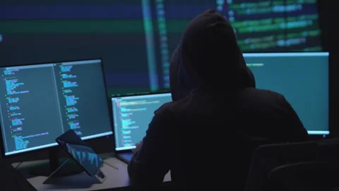 Anonymous Hacker Programming on Multiple Monitors in a Cybersecurity Context 動画素材 336679223