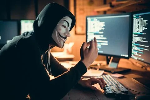 Anonymous hacker showing fuck while hacking stealing information online Stock Photos