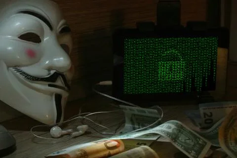 An anonymous hacker tries to crack the operating system's protection Foto stock