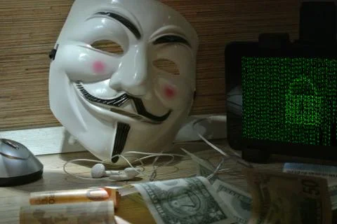 An anonymous hacker tries to crack the operating system's protection Foto stock