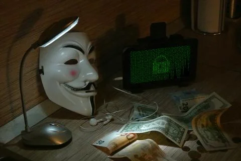 An anonymous hacker tries to crack the operating system's protection Foto stock