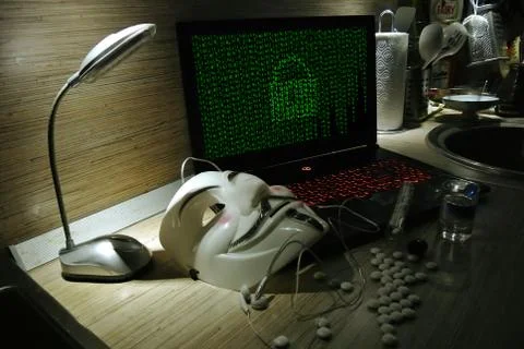 An anonymous hacker tries to crack the operating system's protection Foto stock
