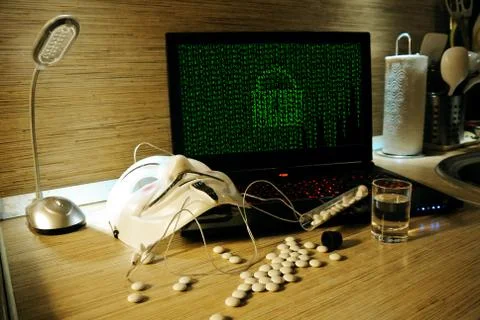 An anonymous hacker tries to crack the operating system's protection Stock Photos