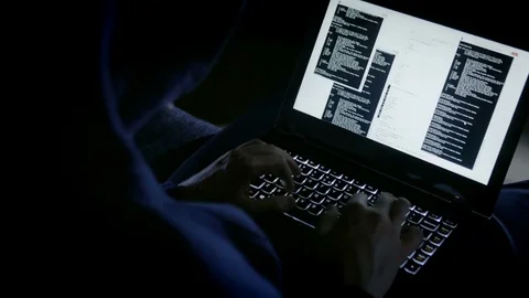 Anonymous hacker typing codes on the laptop keyboard Stock Footage 72544308