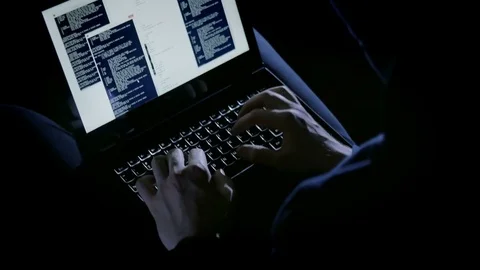 Anonymous hacker typing codes on the laptop keyboard Stock Footage 72544394