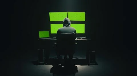 Anonymous hacker using computer in darkness Stock Photos
