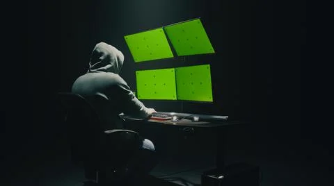 Anonymous hacker using computer in darkness Stock Photos