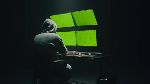 Anonymous hacker using computer in darkness Stock Photos