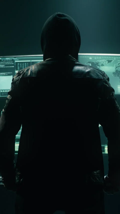 Anonymous hacker watching data on computer monitors Stock Footage 276572664