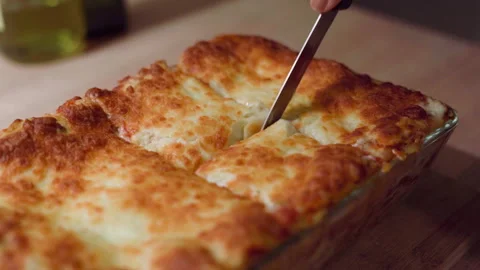 Anonymous hand cutting delicious lasagna in slowmotion Stock Footage 301733893