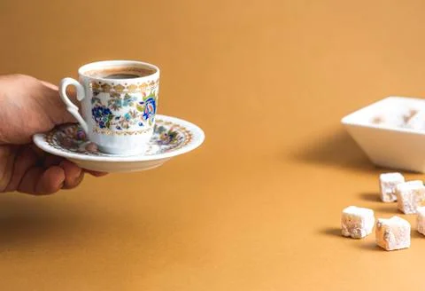 An anonymous hand is serving Turkish coffee and Turkish delight view over mon Stockfoto's