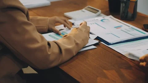 Anonymous hands of an accountant working with documents Stock Footage 333275345