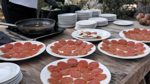 Anonymous hands of a cook preparing fried eggs at a celebration. Видео 144536990