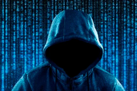 Anonymous hooded computer hacker portrait on computer code background 写真素材