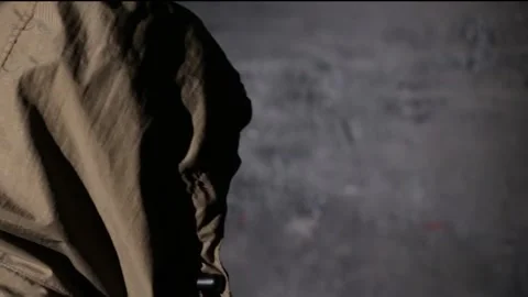Anonymous hooded hacker with back to camera during police interrogation in .. Stock Footage 324955933