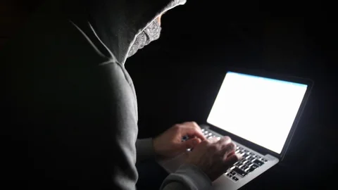 Anonymous Hooded Hacker Programming in Computer Console Breaking Password Stock Footage 106399519