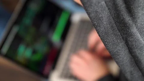 Anonymous Hooded Hacker Programming in Computer Console Breaking Password Stock Photos