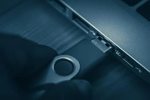 Anonymous inserting flash drive into computer USB port 写真素材