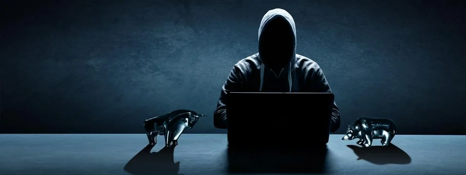 Anonymous internet hacker in front of computer. Web crime concept Stock Photos