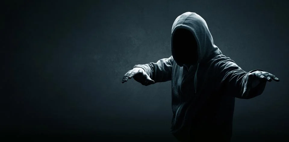 Anonymous internet hacker in front of computer. Web crime concept Stock Photos