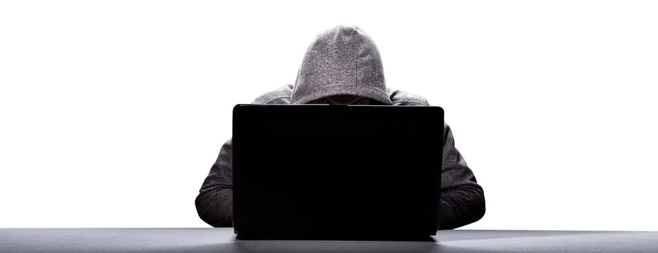 Anonymous internet hacker in front of computer. Web crime concept Stock Photos