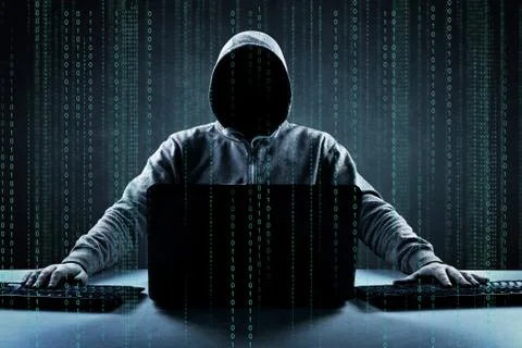 Anonymous internet hacker in front of computer. Web crime concept Stock Photos