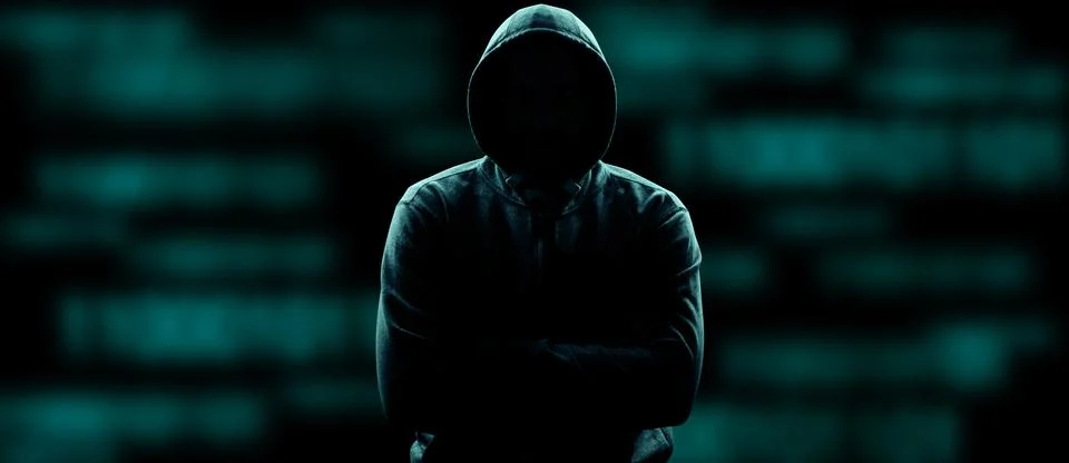 Anonymous internet hacker in front of computer. Web crime concept Stock Photos