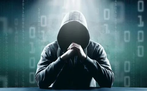 Anonymous internet hacker in front of computer. Web crime concept Stock Photos