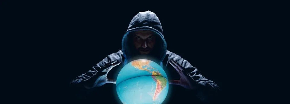 Anonymous internet hacker in front of computer. Web crime concept Stock Photos