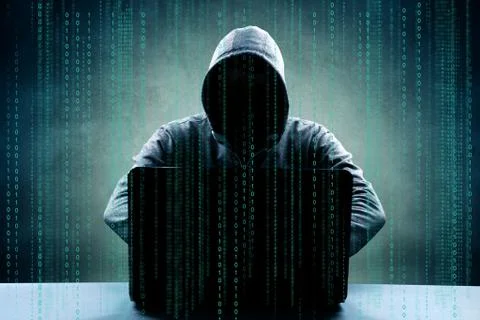 Anonymous internet hacker in front of computer. Web crime concept Stock Photos