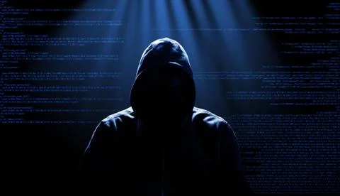 Anonymous internet hacker in front of computer. Web crime concept Stock Photos