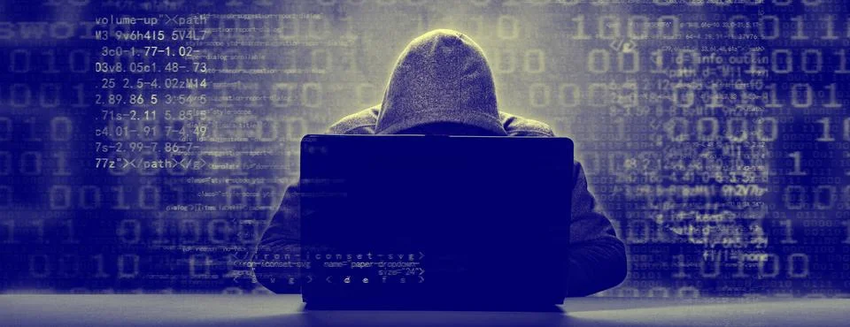 Anonymous internet hacker in front of computer. Web crime concept Stock Photos