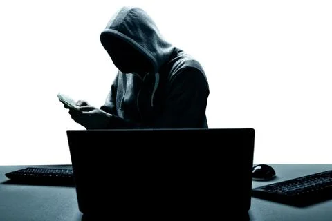 Anonymous internet hacker in front of computer. Web crime concept Stock Photos