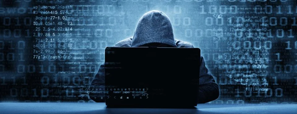 Anonymous internet hacker in front of computer. Web crime concept Stock Photos