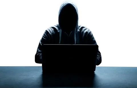 Anonymous internet hacker in front of computer. Web crime concept Stock Photos