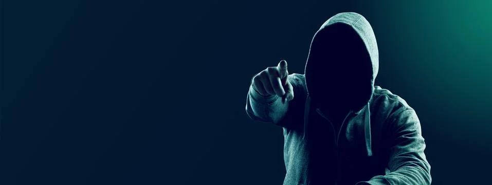 Anonymous internet hacker in front of computer. Web crime concept Stock Photos