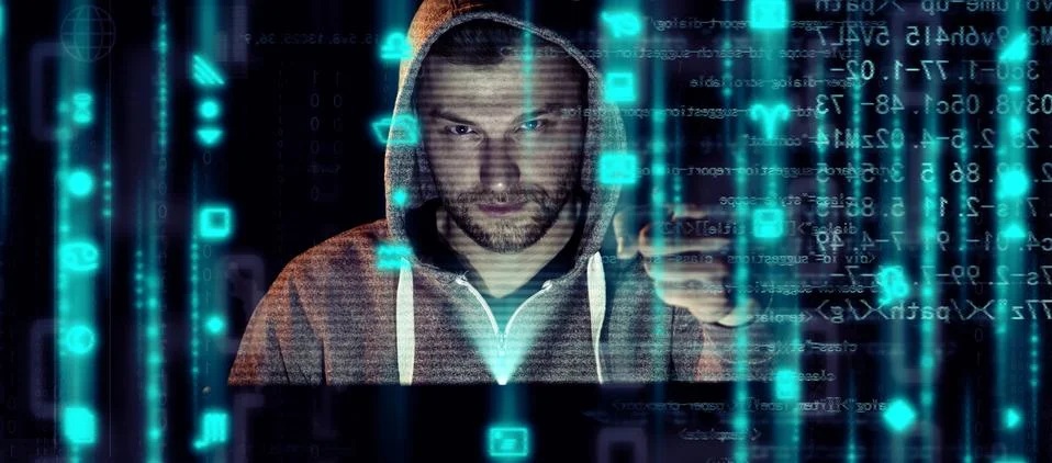 Anonymous internet hacker in front of computer. Web crime concept Stock Photos