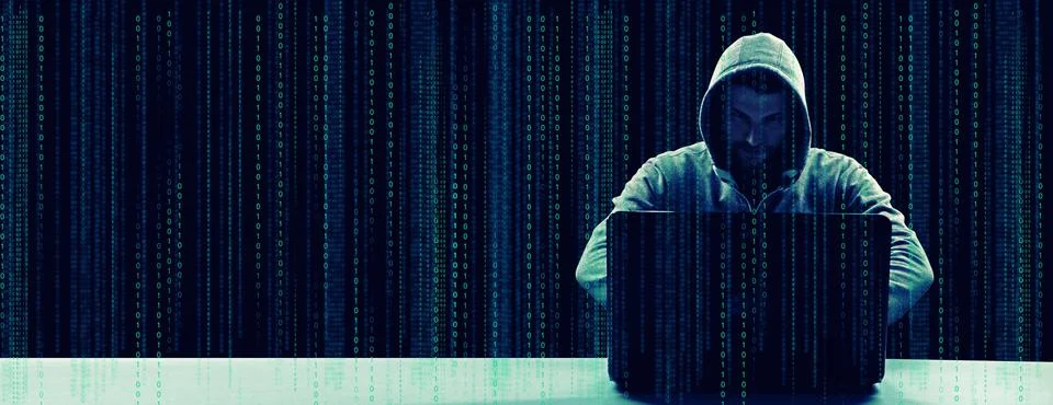 Anonymous internet hacker in front of computer. Web crime concept Stock Photos