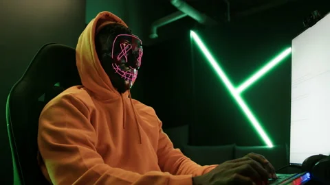 Anonymous internet identity concept. Person in a yellow hoodie in front of a Stock Footage 197443867