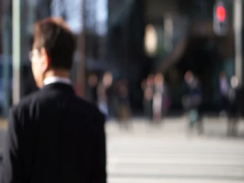 Anonymous Japanese people walking in beautiful sun crossing street in Tokyo Stock Footage
