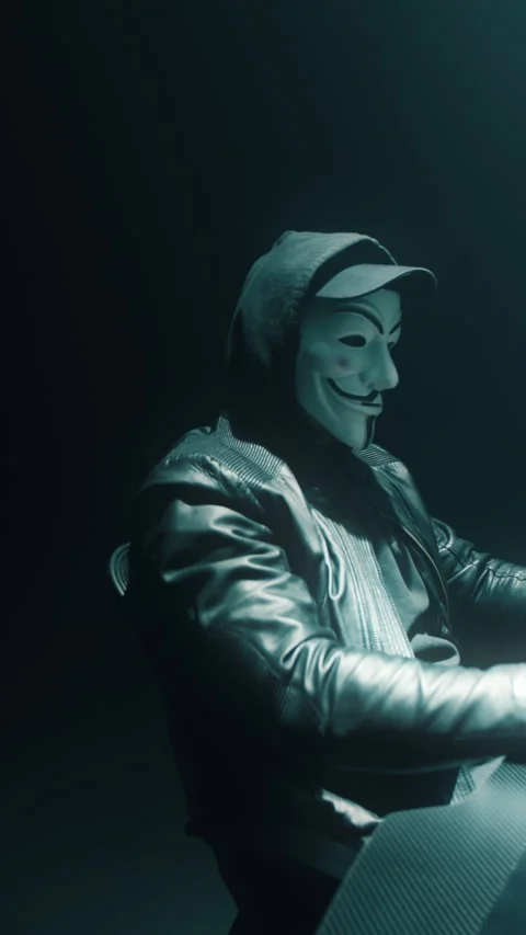 Anonymous man committing cybercrime Stock Footage 276578880