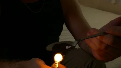 Anonymous man cooking heroin Stock Footage 82330890