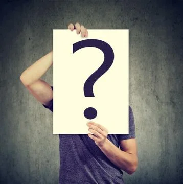 Anonymous man covering face with question mark Stock Photos