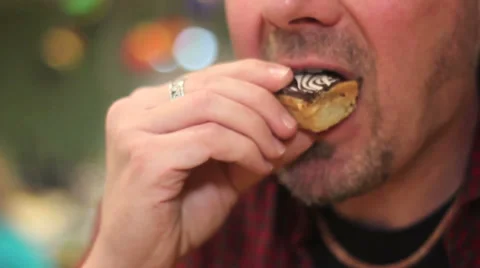 Anonymous man eats cake Stock Footage 34343952