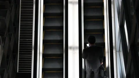 Anonymous man on escalator 스톡 동영상 25821934