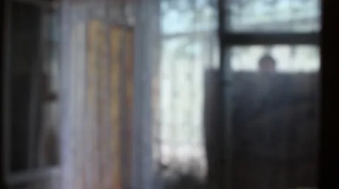 Anonymous man hangs out linen on a balcony Stock Footage 52683652