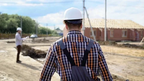 Anonymous man holding tool while working on site in summer Stock Footage 77188023
