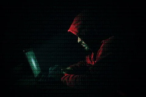 Anonymous man with laptop and binary code in darkness Stock Photos