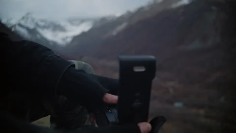 Anonymous Man Loading Film Camera Against Mountain Backdrop Stock Footage 302214859